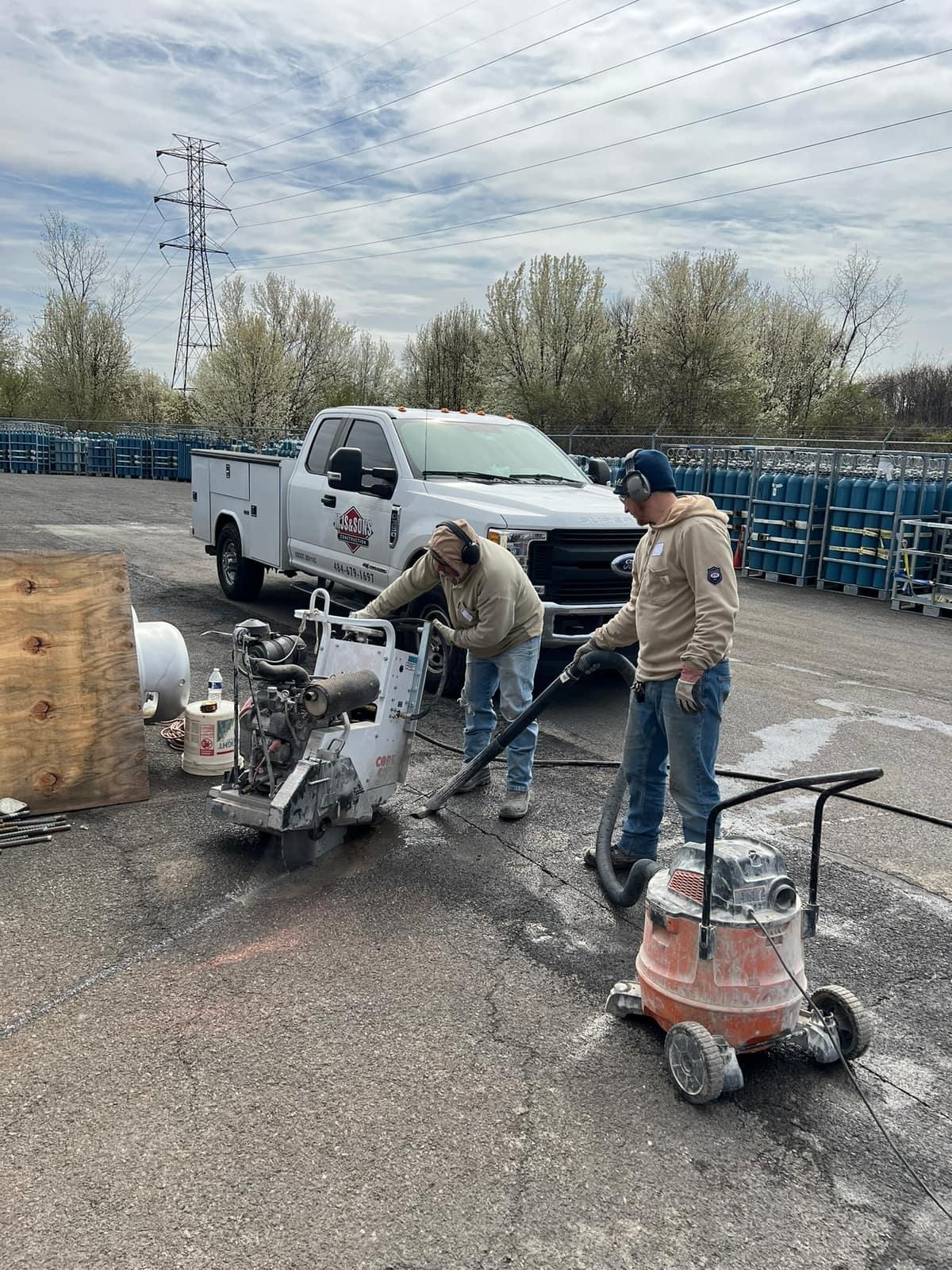 Crew diamond blade saw cutting the slab cut line on site by MJS & Sons Construction