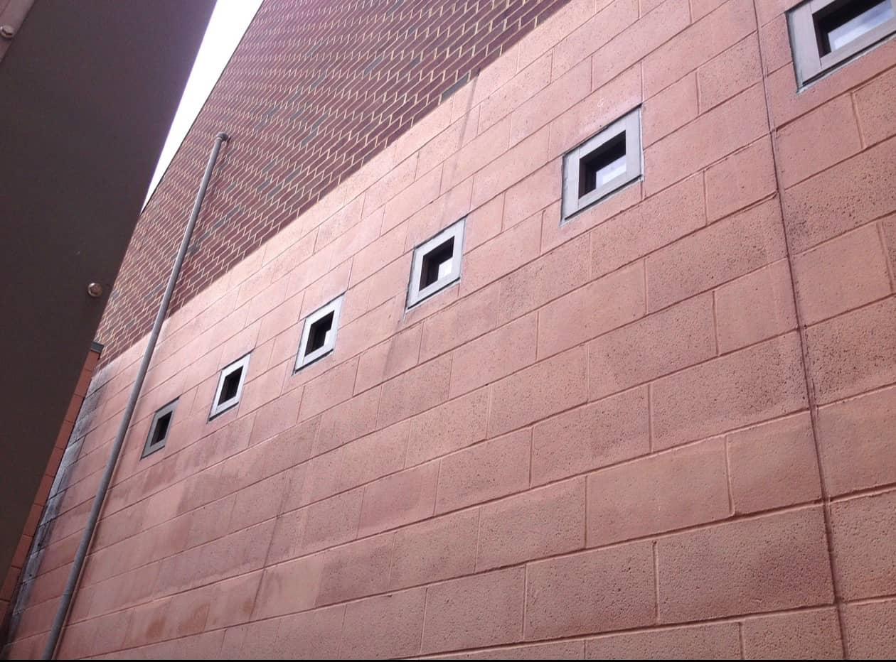 Block wall with the original small openings before cutting by MJS & Sons Construction