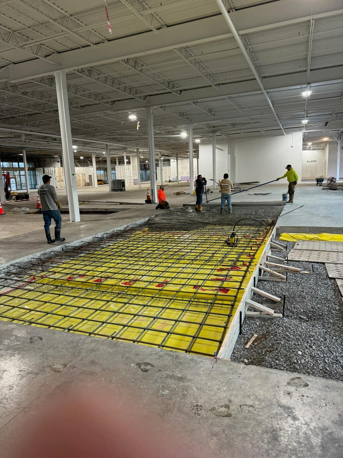 Crew screeding the foundation pour by MJS & Sons Construction