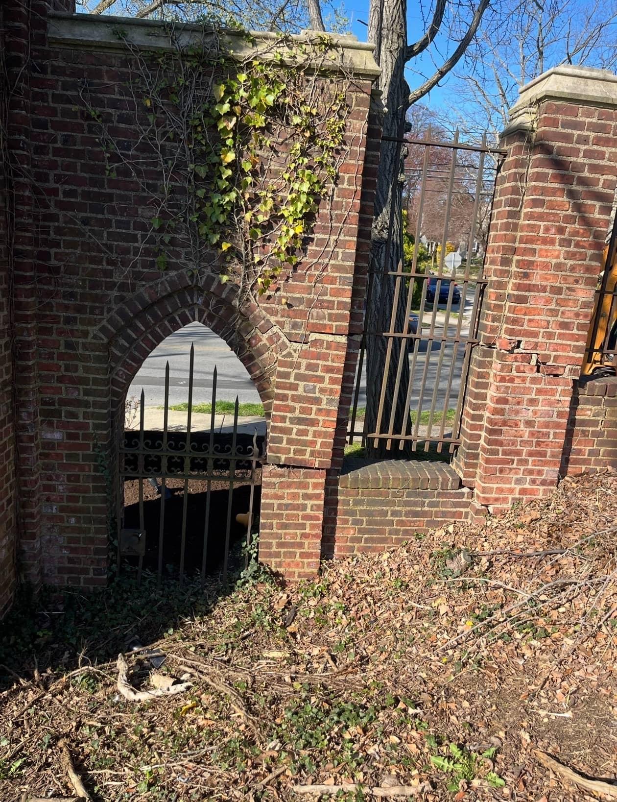Cracked stone gate pillar before restoration by MJS & Sons Construction