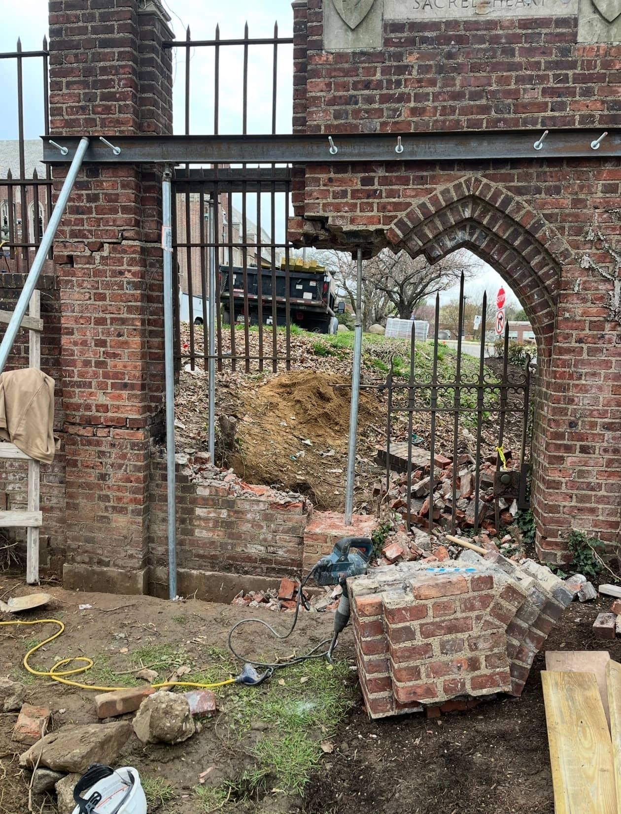 Steel header set during Sacred Heart stone gate repair by MJS & Sons Construction