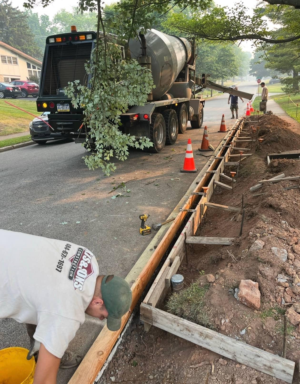 Curb forms crew mixer morning by MJS & Sons Construction